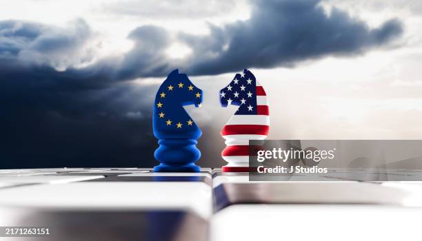 face off of two rooks in us and eu flag colors with moody sky - european union stock pictures, royalty-free photos & images