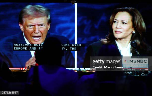 People watch the ABC News presidential debate between Democratic presidential nominee, U.S. Vice President Kamala Harris and Republican presidential...