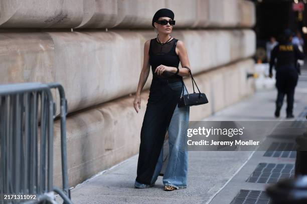 Yana Echko seen wearing Alexander McQueen black sunglasses, THE ROW black Xhefri hat, Justine Clenquet silver earrings and rings, YSL black leather...
