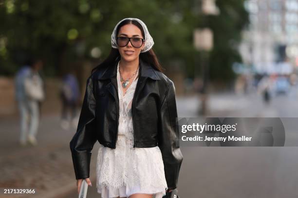 Olga Sokolenko seen wearing Saint Laurent black aviator sunglasses with sheer lenses, white lace hair band, Saint Laurent silver necklace with heart...
