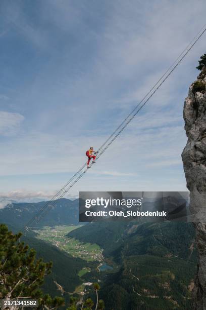 woman climbing the ladder on via ferrata in austria in autumn - stairway to heaven stock pictures, royalty-free photos & images
