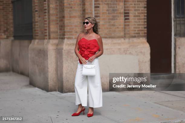 Olga Ferrara seen wearing silver / black sunglasses, Leibish diamond jewelry, Innovare Denim red bandeau top, Kobi Halperin white cotton wide leg...
