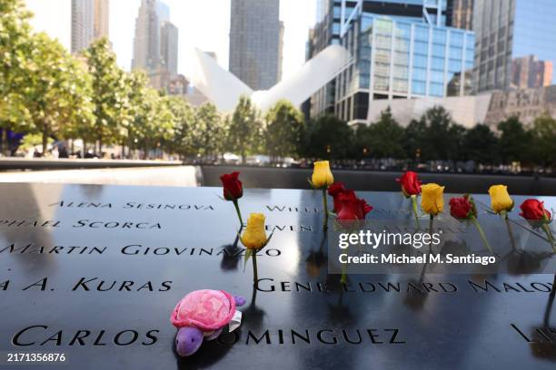 Flowers are seen on names of victims of the 9/11 terror attack during the annual 9/11 Commemoration Ceremony at the National 9/11 Memorial and Museum...