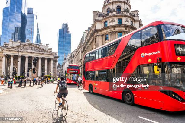 buses and cyclists sharing the street - stage coach bus stock pictures, royalty-free photos & images