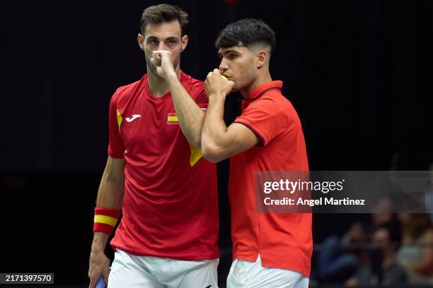 Carlos Alcaraz and Marcel Granollers of Spain talk during the 2024 Davis Cup Finals Group Stage doubles match between Czechia and Spain at Pabellon...