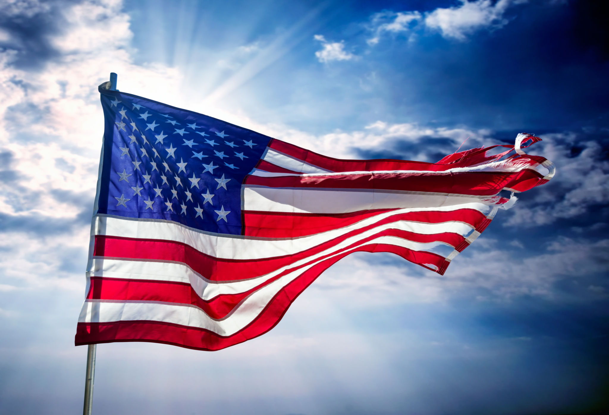 Close up American flag over dramatic sky Close up American flag over dramatic sky