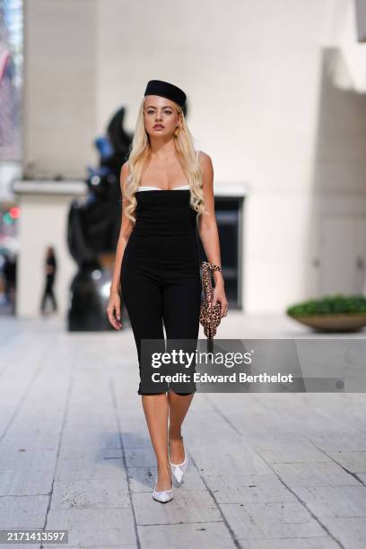 Guest wears black pillbox hat, white and black strapless bodycon midi dress, dark brown Leopard handbag, white sheer mesh pointed toe kitten heels,...