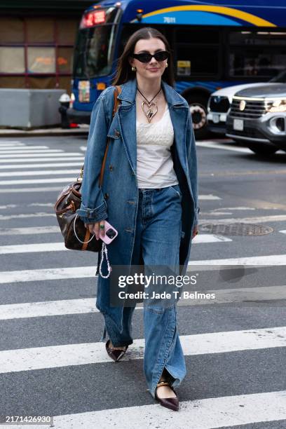 Guest is seen wearing a white top, blue denim trench coat, blue denim pant, carrying a brown bag, brown flat shoes and black sunglasses outside the...