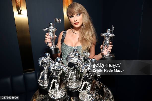 Taylor Swift poses with her awards backstage during the 2024 MTV Video Music Awards at UBS Arena on September 11, 2024 in Elmont, New York.