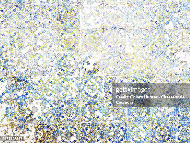 overexposed shot of old blue and yellow earthenware tiles (azulejo) on the facade of a house in porto, portugal. sunlight. natural colors and patina. - portuguese culture stock pictures, royalty-free photos & images