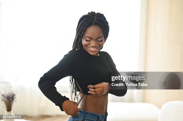 cheerful black woman getting ready. - black woman torso stock pictures, royalty-free photos & images