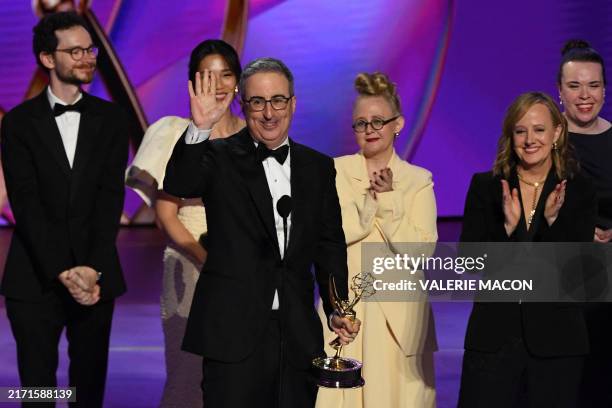 British-US comedian John Oliver accepts the Outstanding Scripted Variety Series award for "Last Week Tonight with John Oliver" onstage during the...