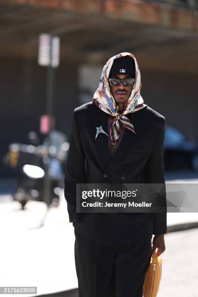 Jarred Vanderbilt is seen wearing a multicolored “Forever Scarf 90” in silk twill with horse prints from Hermès around his head, a black New Era cap...