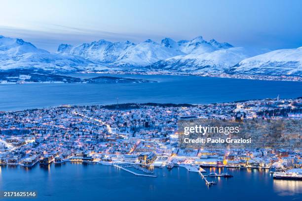 tromso covered with snow at dusk - tromso stock pictures, royalty-free photos & images