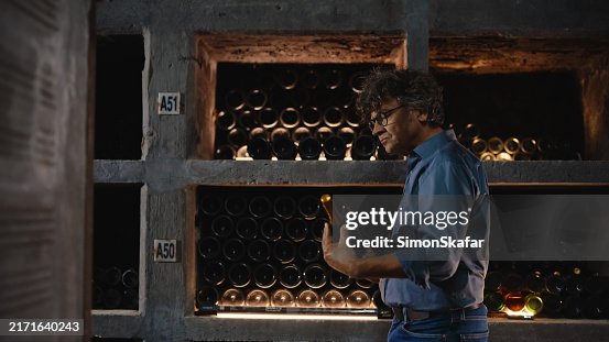 Senior Winemaker Evaluating Bottled Selection in Cellar Senior Winemaker Evaluating Bottled Selection in Cellar