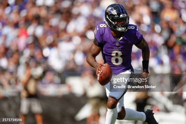 Lamar Jackson of the Baltimore Ravens rolls out to throw a pass during the second half against the Las Vegas Raiders at M&T Bank Stadium on September...