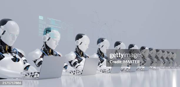 digital generated image of multiple robots working on laptops siting in a raw. smart technology, automation and artificial intelligence concept. - production assistant stock pictures, royalty-free photos & images