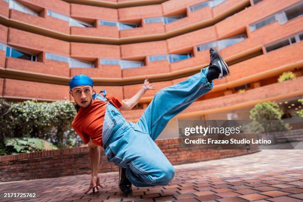 portrait of a young man dancing outdoors - breakdancing stock pictures, royalty-free photos & images
