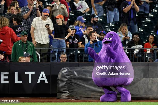 McDonald's character Grimace is seen on the field during the seventh inning between the Washington Nationals and the New York Mets at Citi Field on...