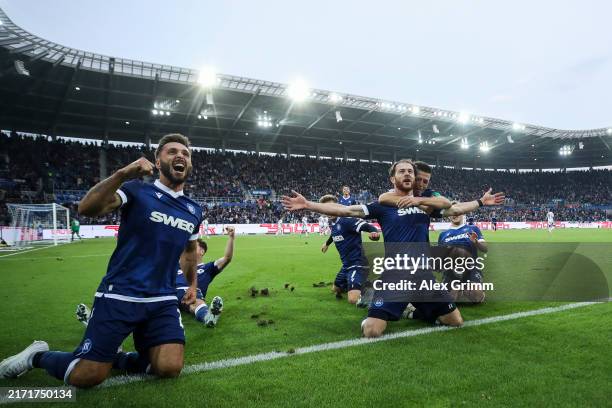 Budu Zivzivadze of Karlsruher SC celebrates with team mates after scoring the team's first goal during the Second Bundesliga match between Karlsruher...