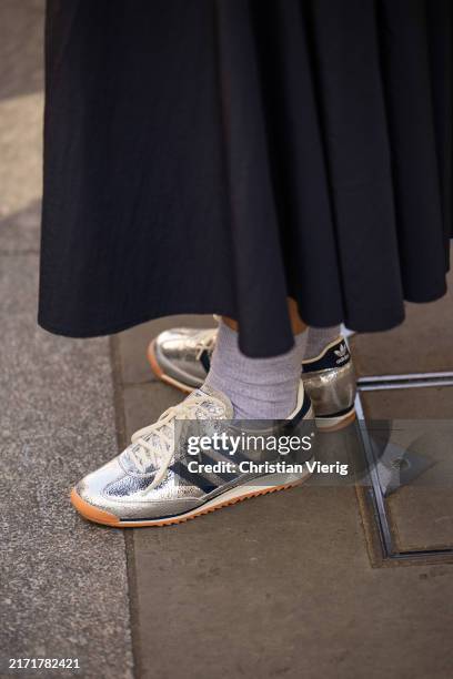 Guest wears silver Adidas sneakers outside Bora Aksu during London Fashion Week September 2024 on September 13, 2024 in London, England.