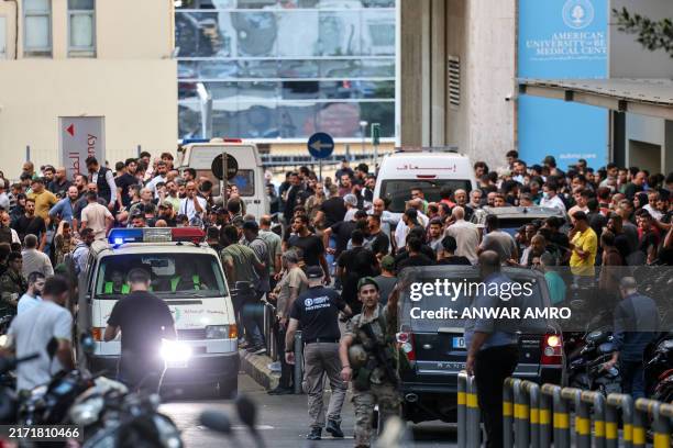Ambulances are surrounded by people at the entrance of the American University of Beirut Medical Center, on September 17 after explosions hit...