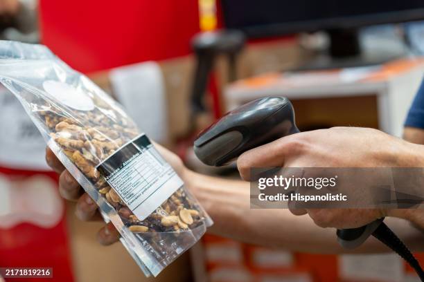 retail clerk scanning a bar code of a product at the supermarket - scan barcode stock pictures, royalty-free photos & images