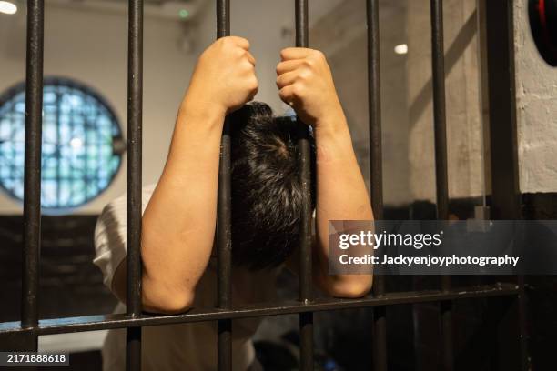 stress among prisoners in a prison cell. - cellule de prison photos et images de collection
