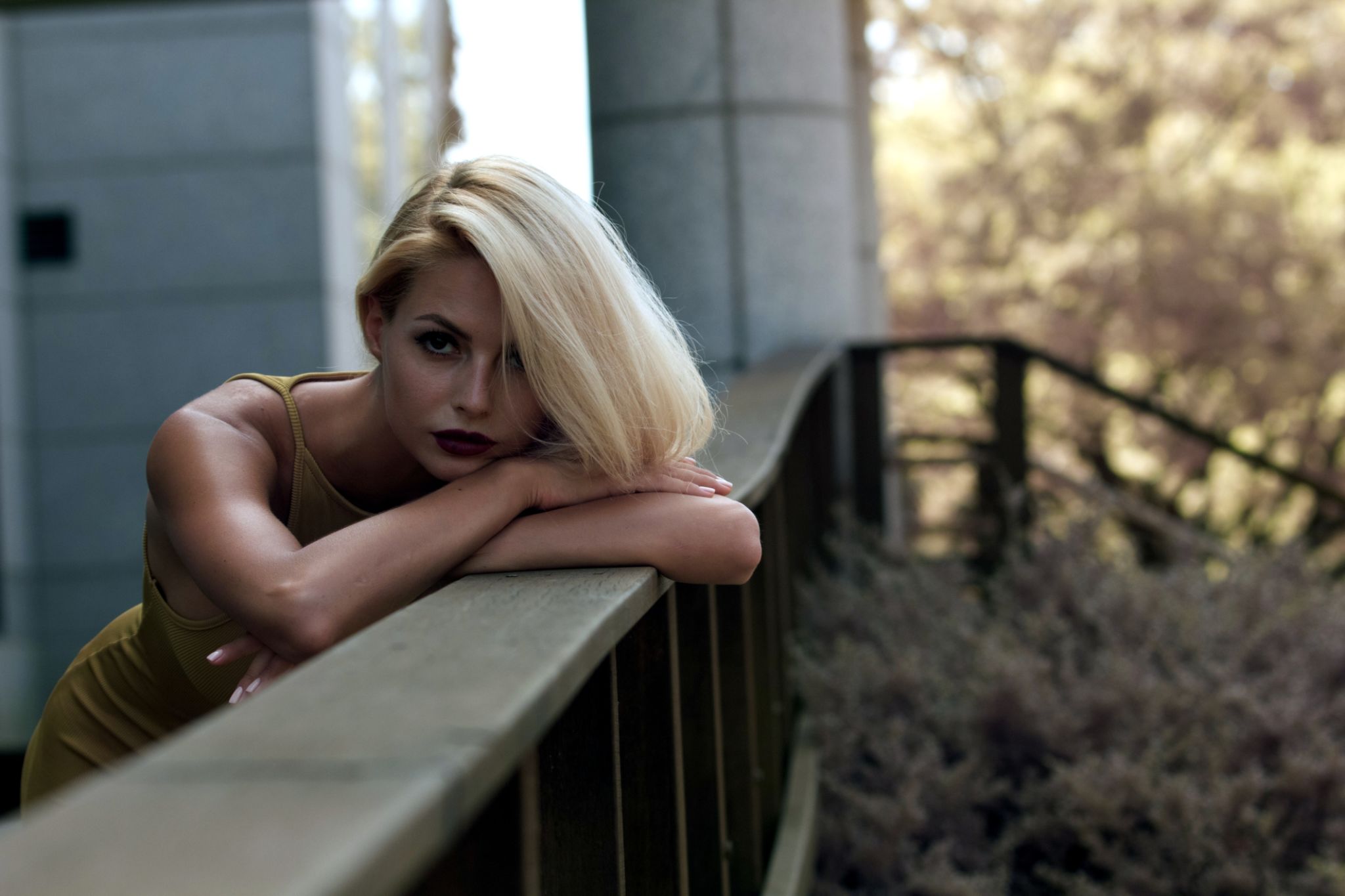 Beautiful Fashion Model Leaning On Wooden Railing Beautiful Fashion Model Leaning On Wooden Railing
