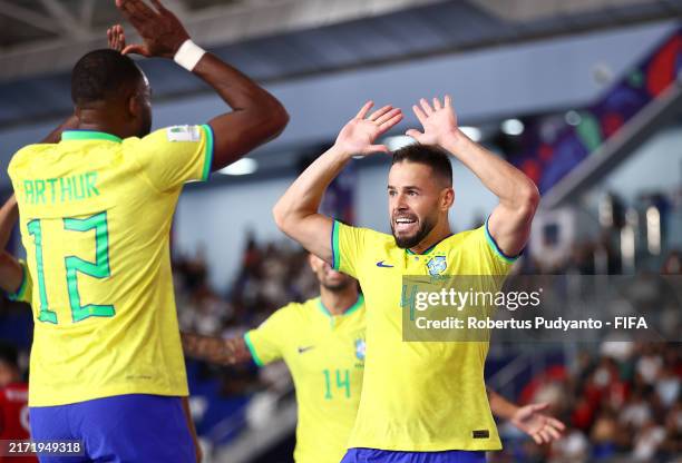 Marlon celebrates scoring his team's second goal with teammate Arthur during the FIFA Futsal World Cup Uzbekistan 2024 match between Brazil and Cuba...