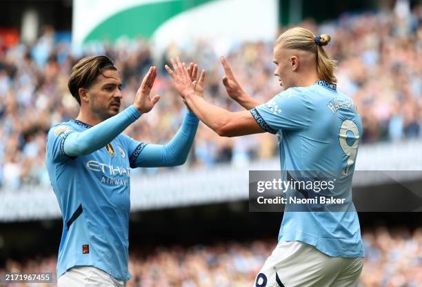 Erling Haaland of Manchester City celebrates scoring his team's second goal with team mate Jack Grealish of Manchester City during the Premier League...