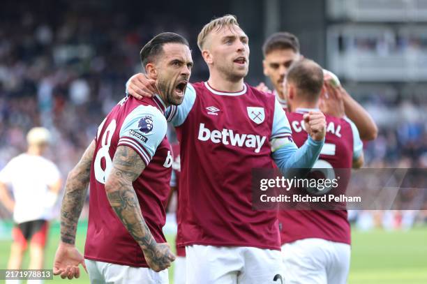 Danny Ings of West Ham United celebrates scoring his team's first goal with teammate Jarrod Bowen during the Premier League match between Fulham FC...