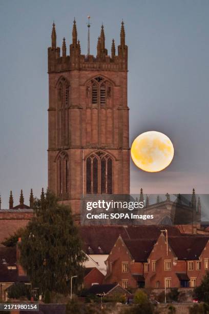The Harvest Super Moon rises infront of the St Lawrence's church.