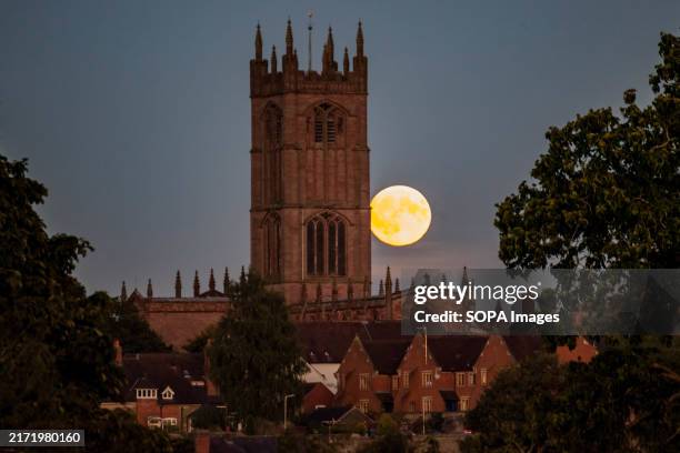 The Harvest Super Moon rises infront of the St Lawrence's church.