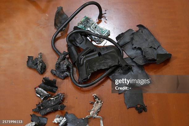Photo taken on September 18 in Beirut's southern suburbs shows the remains of exploded pagers on display at an undisclosed location. Hundreds of...