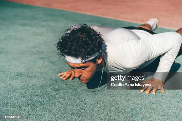 a dedicated and disciplined sportsman doing pushups with vigor and motivation - hypertrophy stock pictures, royalty-free photos & images