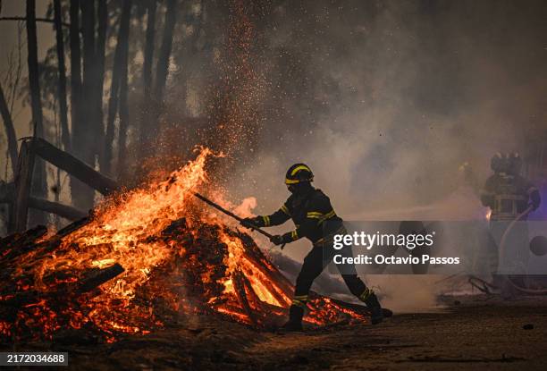 Firefighters combat a wildfire in Espiunca on September 18, 2024 in Arouca, Portugal. Portugal has asked the EU to send more fire-fighting planes to...