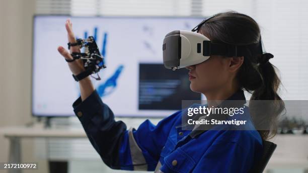mastering robotics: coding & testing cyborg hands with vr in the lab. - continuous learning stock pictures, royalty-free photos & images