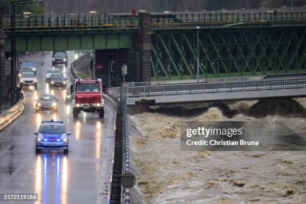 Cars drive by rising water of the Wien River during heavy rain on September 15, 2024 in Vienna, Austria. There have been extreme weather and flood...