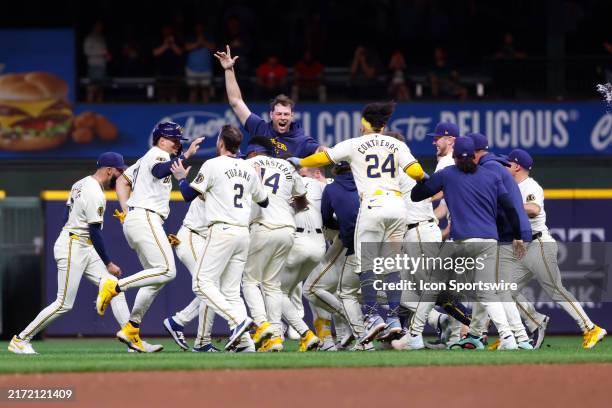Milwaukee Brewers pitcher Trevor Megill soars high above the victory celebration during a game between the Milwaukee Brewers and the Philadelphia...