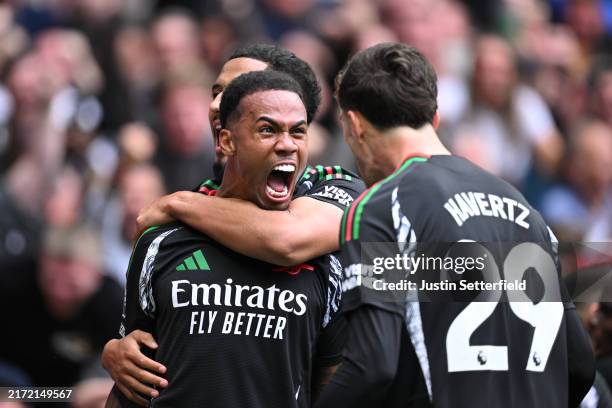 Gabriel of Arsenal celebrates scoring his team's first goal with teammates William Saliba and Kai Havertz of Arsenal during the Premier League match...