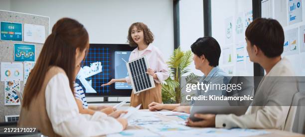 asian business people team brainstorm meeting in sustainable corporate office. presentation esg project planning, solar panel, wind turbine power energy generation. environmental conservation concept - climate stock pictures, royalty-free photos & images