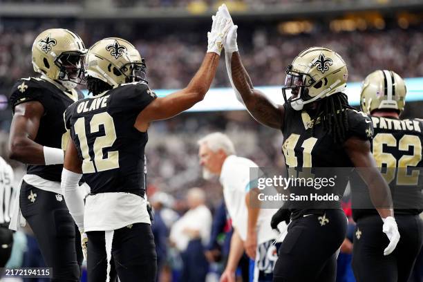 Alvin Kamara and Chris Olave of the New Orleans Saints celebrate a touchdown during the second quarter at AT&T Stadium on September 15, 2024 in...