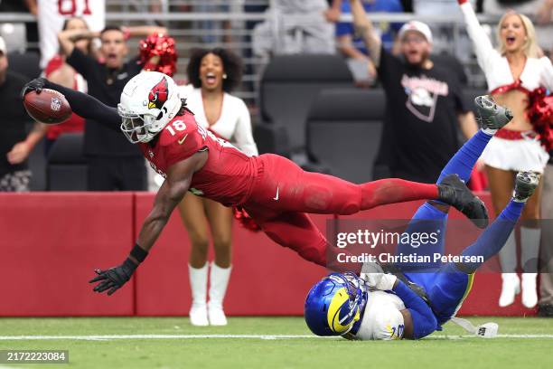 Marvin Harrison Jr. #18 of the Arizona Cardinals scores a touchdown over Kamren Curl of the Los Angeles Rams during the first quarter at State Farm...