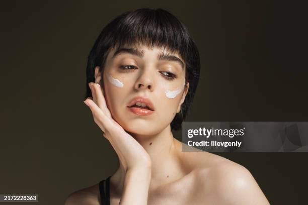 cream on face. scin care. beauty portrait. woman - body care and beauty stock pictures, royalty-free photos & images