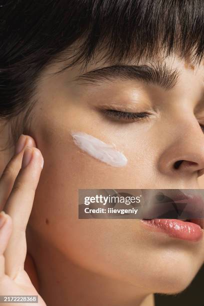 cream on face. scin care. beauty portrait. woman - skin stock pictures, royalty-free photos & images