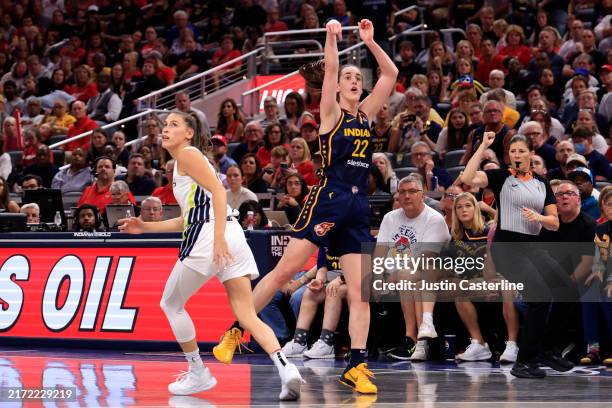 Caitlin Clark of the Indiana Fever breaks the rookie season scoring record with a three pointer during the second half against the Dallas Wings at...