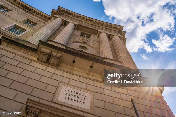 The sun flairs over the side of the U.S. Internal Revenue Service headquarters building on September 15 in Washington, DC.
