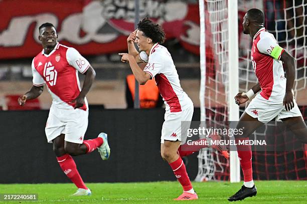 Monaco's French midfielder Maghnes Akliouche celebrates with teammates after scoring his team's first goal during the UEFA Champions League 1st round...