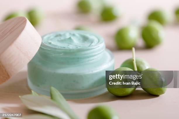 olive moisturizer - cosmetics stock pictures, royalty-free photos & images